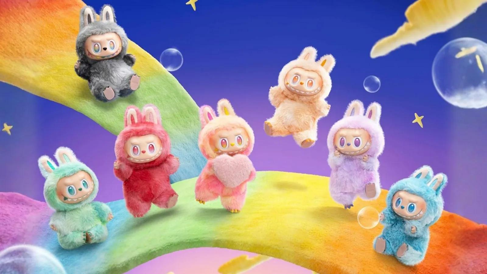 A collection of colorful Labubu plush figures posing on a bright rainbow path under a starry sky.