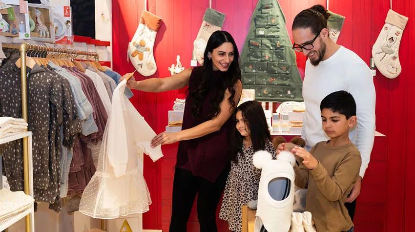 Family shopping for gifts at a festive themed holiday market