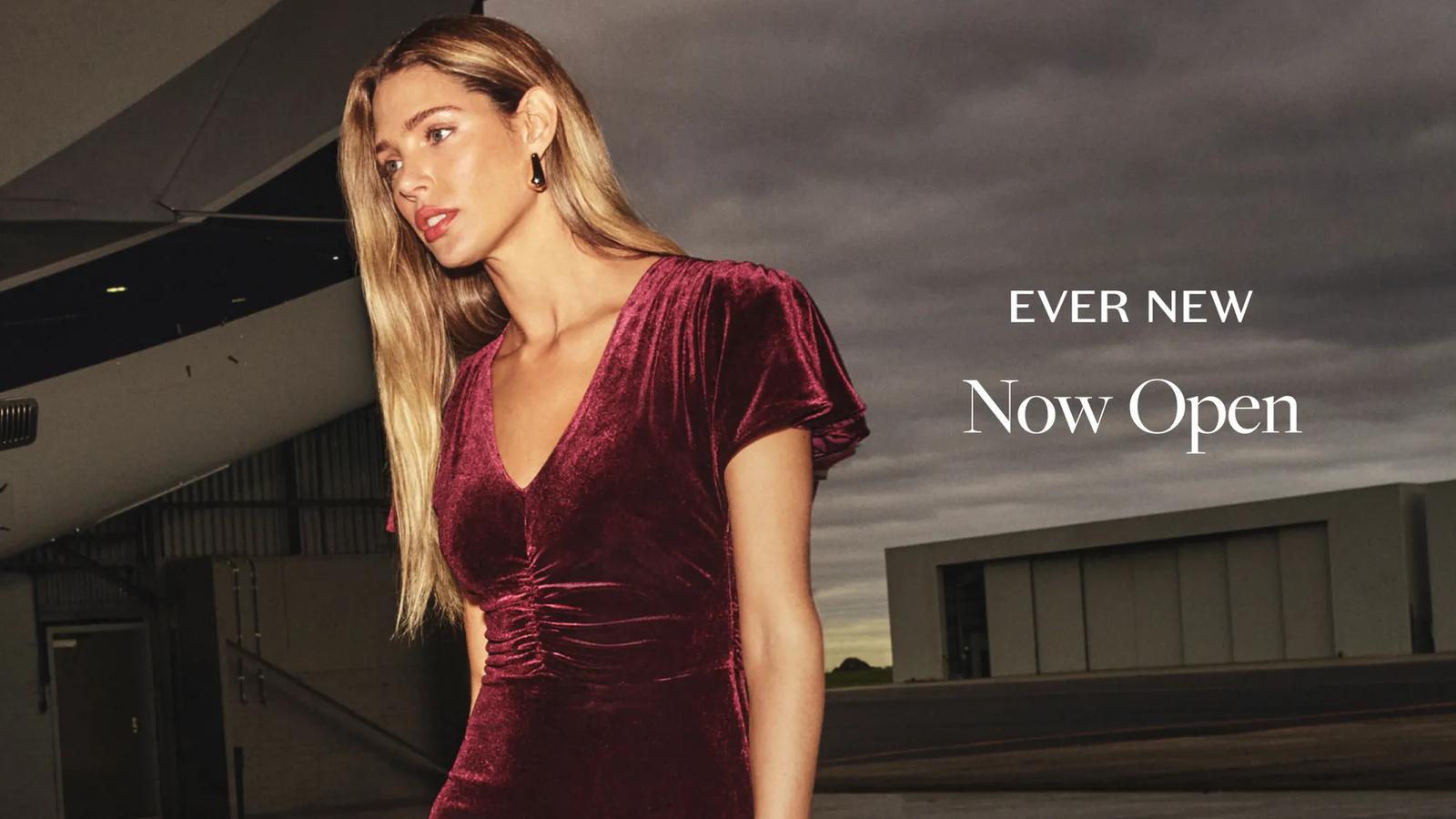 An Ever New "Reopening Soon" banner featuring a model in a trench coat by a harbor.